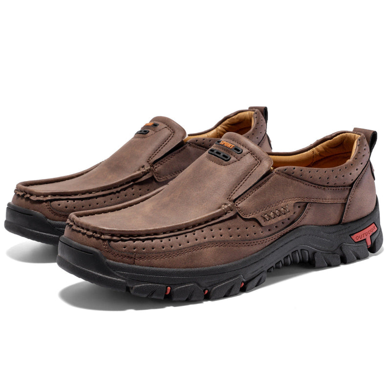 Men's dark brown leather slip-on outdoor shoes with side stitching, perforations, and treaded sole