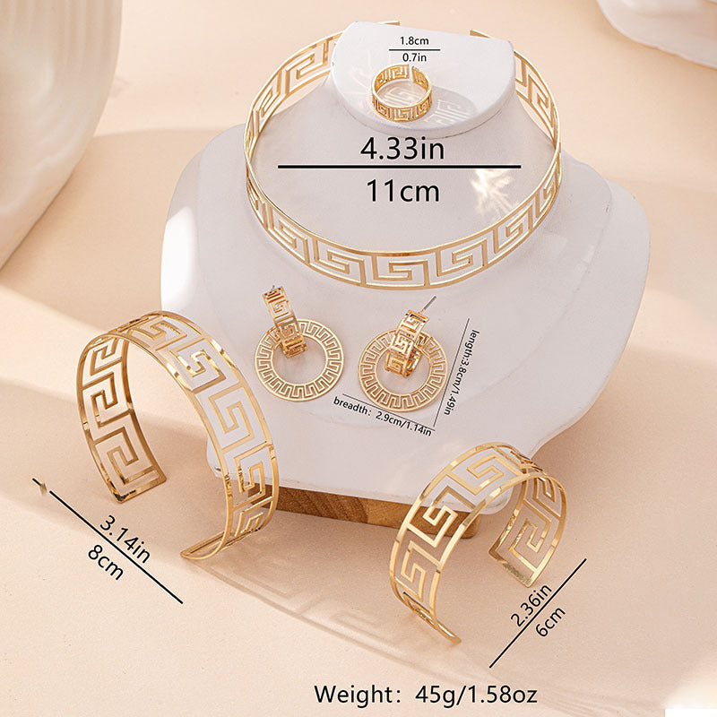 Gold jewelry set including bracelet, ring, and earrings on a white stand with measurements.