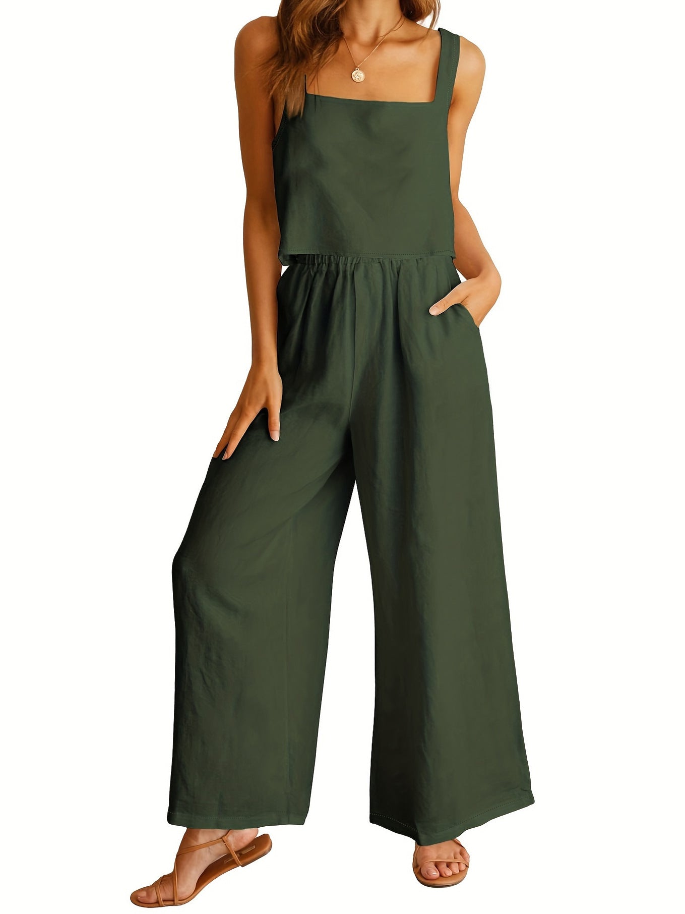 Green jumpsuit worn by a model on a white background