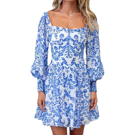 Blue and white floral dress with long sleeves on a white background