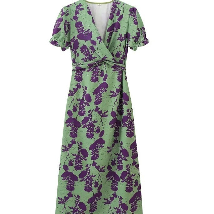 Green dress with purple floral pattern on a white background