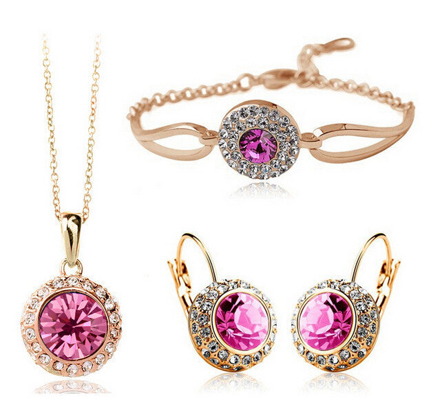 Jewelry set with pink gemstones on a white background