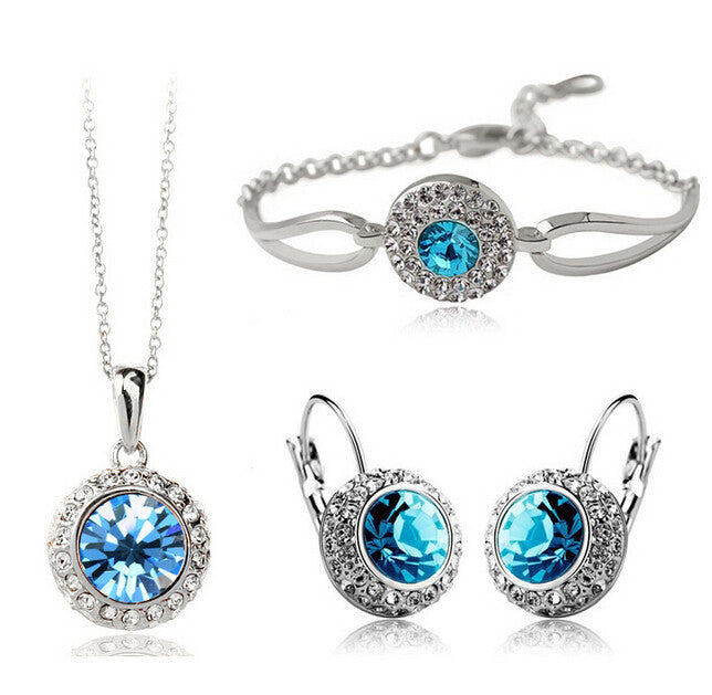 Jewelry set with blue gemstones on a white background