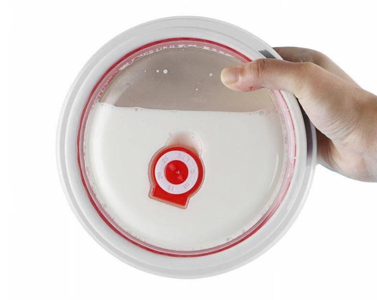 Hand holding a container with a red and white logo on a white background