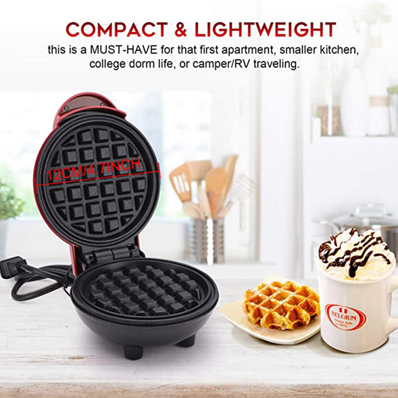 Compact waffle maker on a kitchen counter with waffles and a mug.