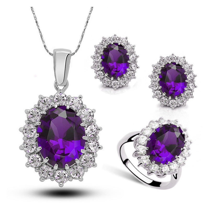 Jewelry set with purple gemstones on a white background