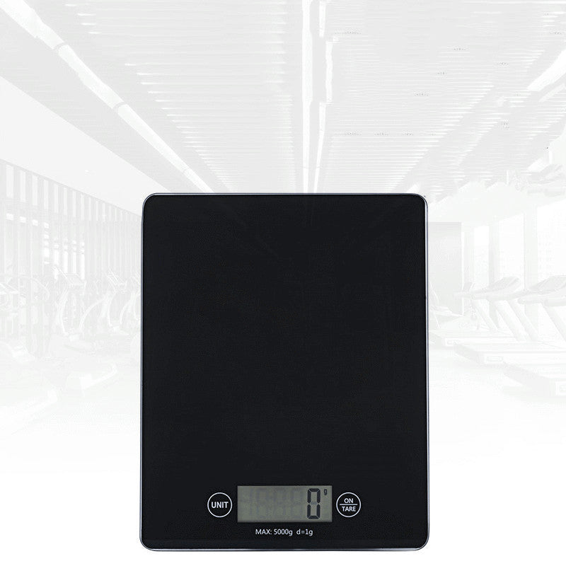 Black digital kitchen scale on a white background