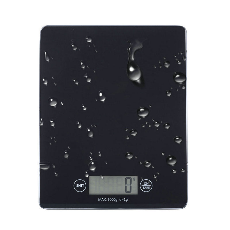 Black digital kitchen scale with water droplets on the surface