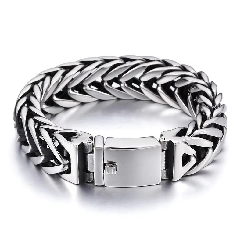 Silver braided bracelet with a clasp on a white background