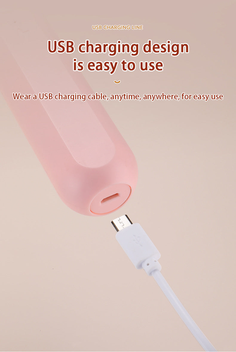 USB charging cable with pink cylindrical device on a beige background