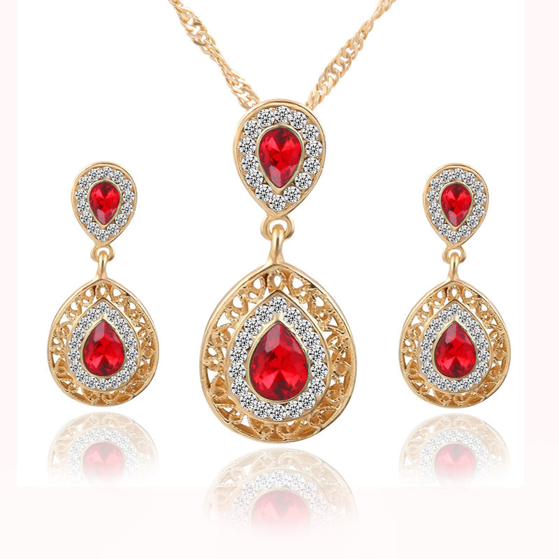 Gold-tone necklace pendant and matching red teardrop crystal earrings set