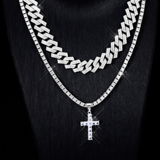 Silver chain necklace with a cross pendant on a black background