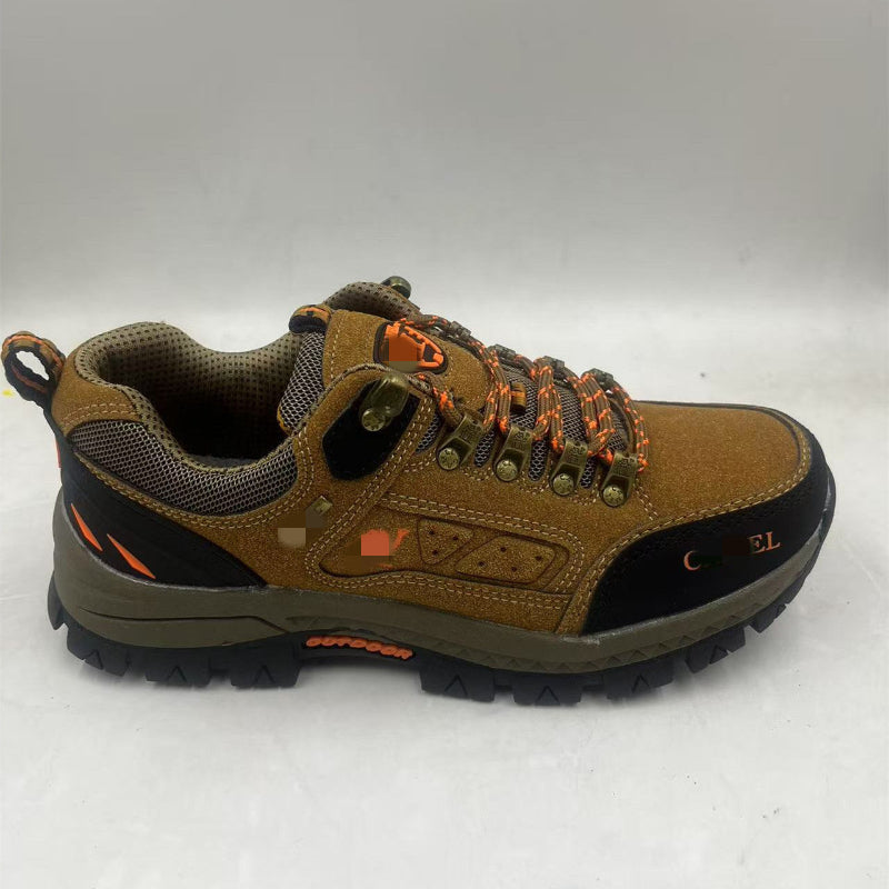 Brown hiking shoe with orange accents on a white background