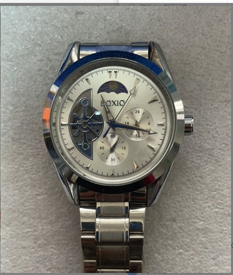 Silver watch with a detailed face on a gray background