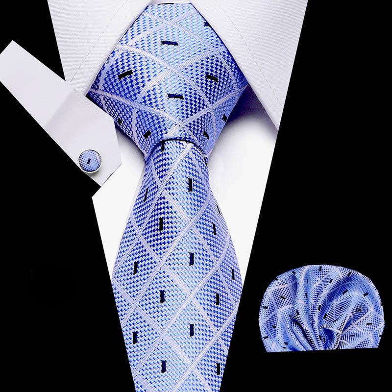 Blue patterned tie with matching pocket square on a white shirt background