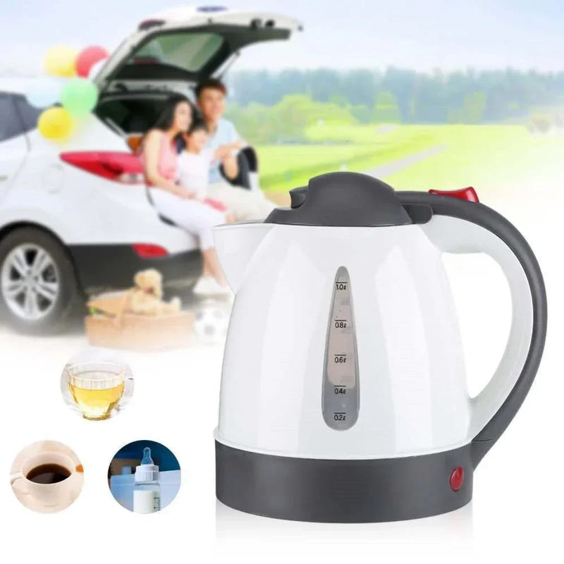 White electric car kettle with black handle and spout, cup of hot tea