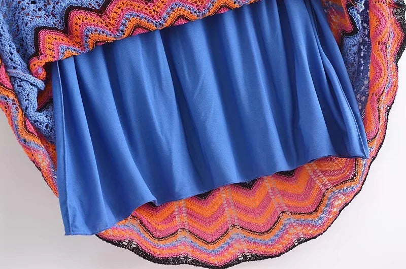 Blue fabric with colorful crochet border on a white background