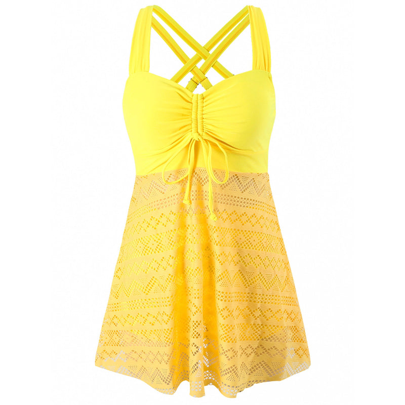 Yellow lace dress with criss-cross straps on a white background