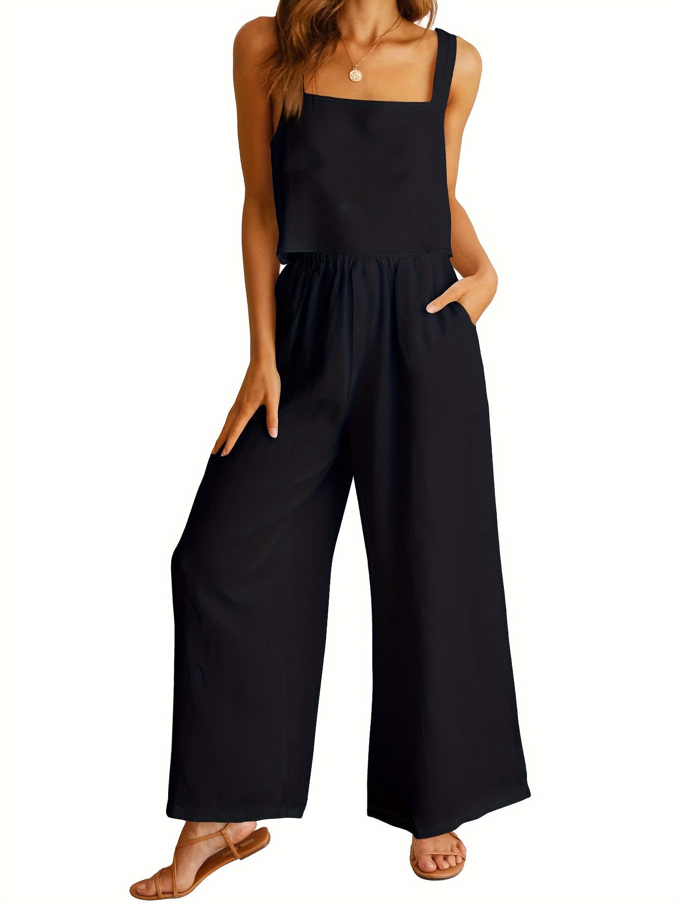 Black jumpsuit worn by a model on a white background