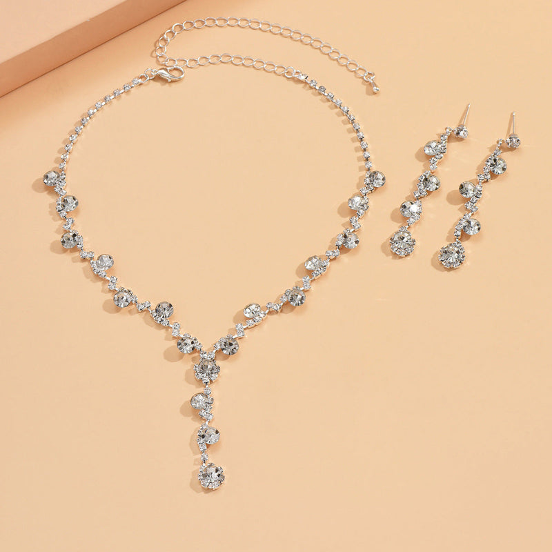 Crystal tennis-style necklace with teardrop rhinestone ear stud earrings