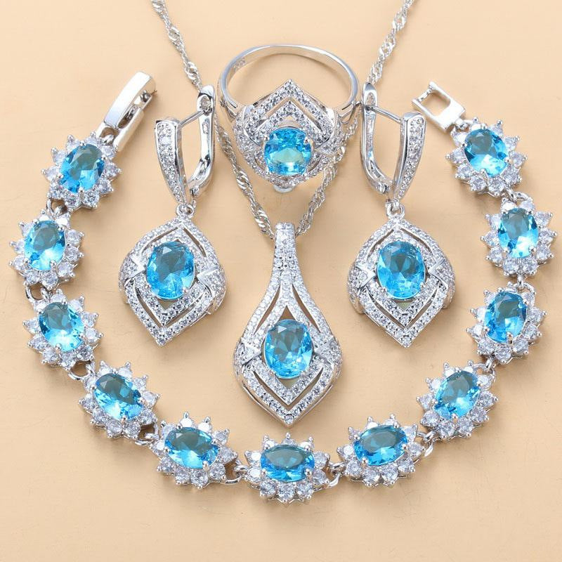 Jewelry set with blue gemstones on a beige background