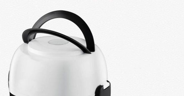 White electric kettle with black handle on a white background