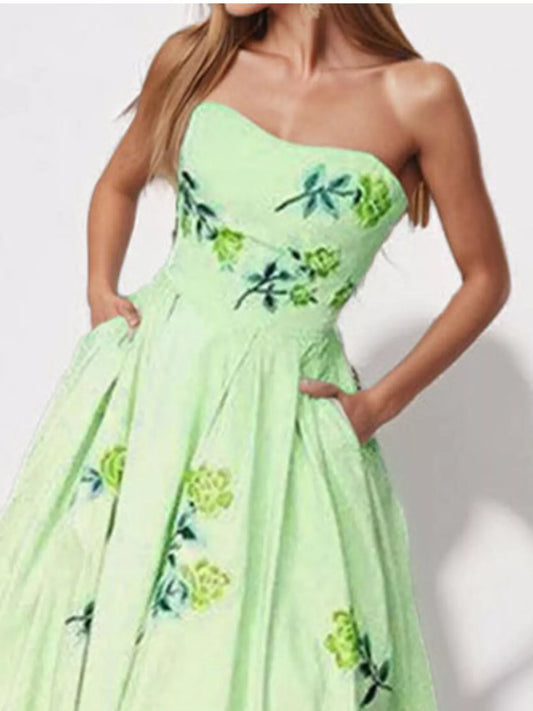 Light green floral tube maxi dress with fitted bodice and full gathered skirt
