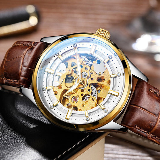 Luxury watch with brown leather strap and gold and silver case on a wooden surface