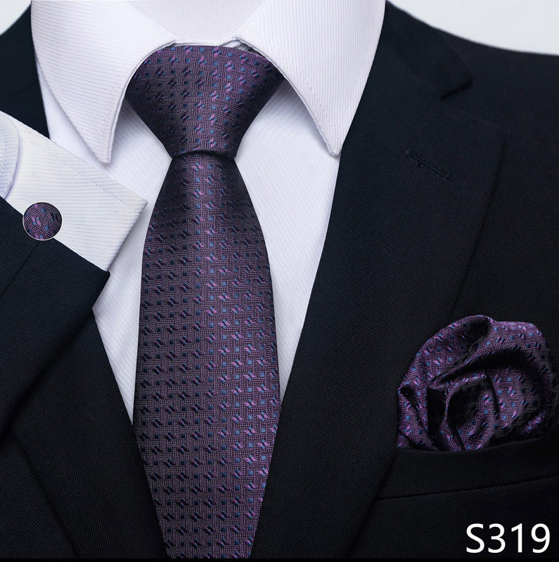 Black suit with a purple patterned tie and pocket square on a white background