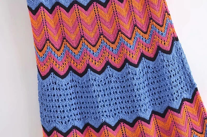Colorful crocheted shawl with zigzag pattern on a white background