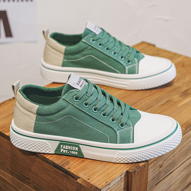 Green and beige sneakers on a wooden surface with a blurred background