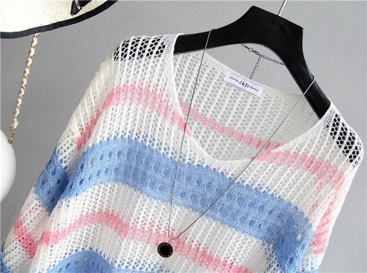 Knitted cardigan with colorful pattern on a hanger