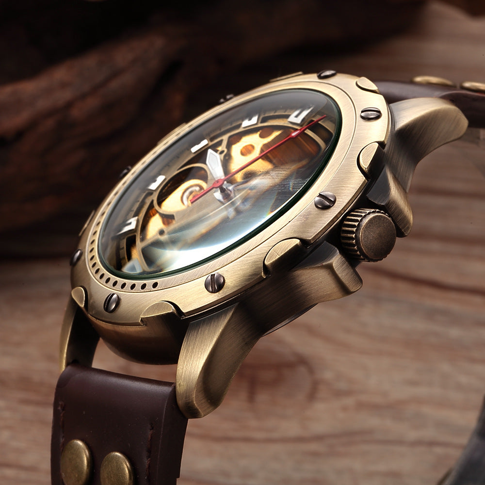 Bronze watch with brown leather strap on a wooden background