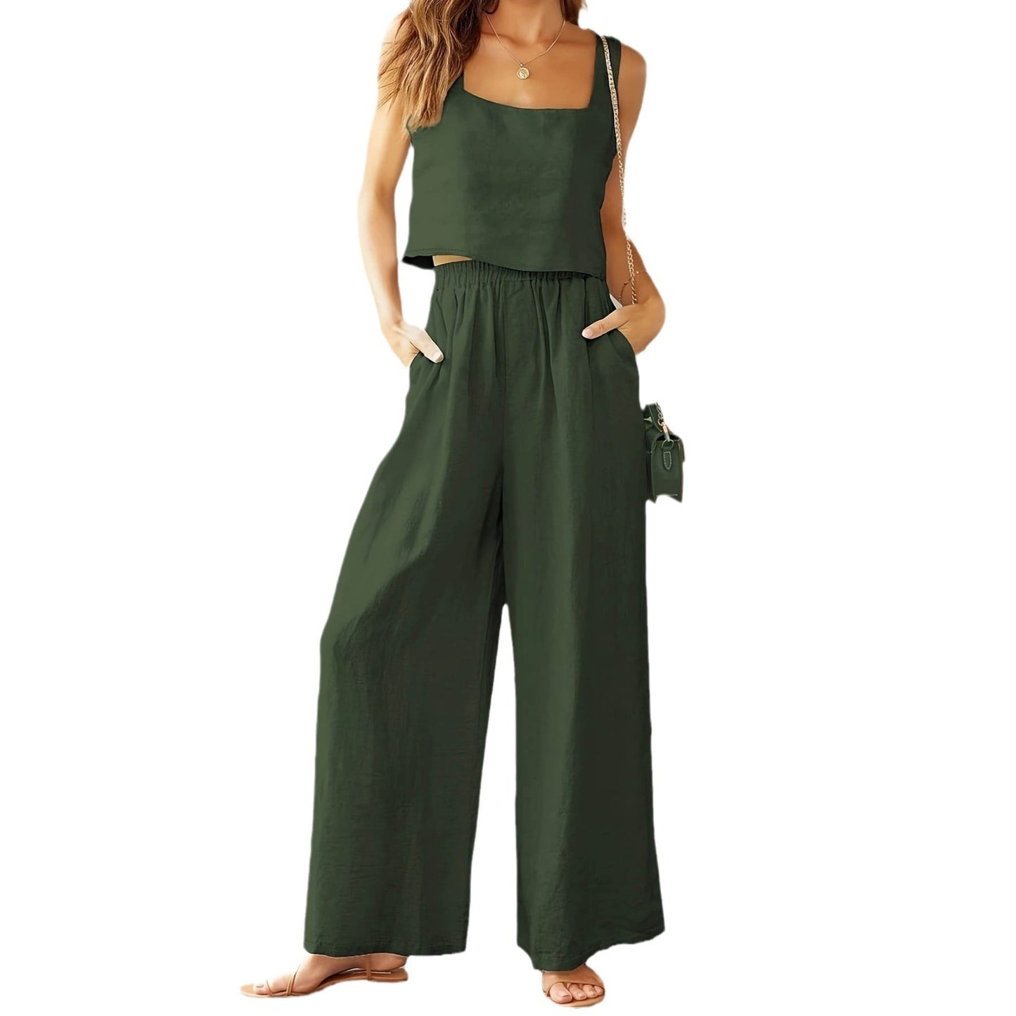 Green jumpsuit worn by a model on a white background