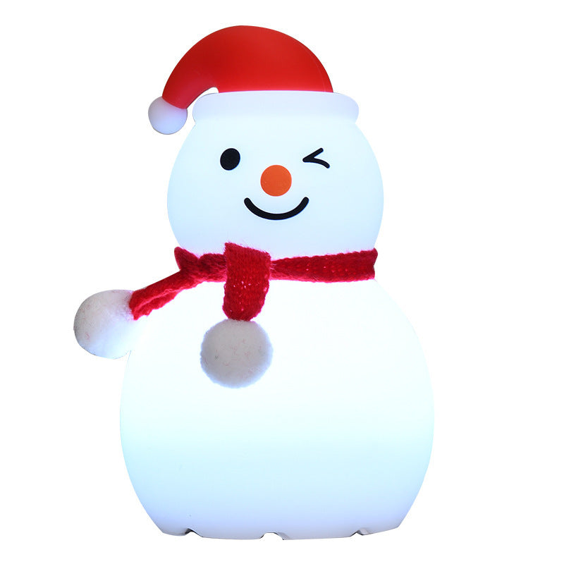 Snowman-shaped night light with a red hat and scarf on a white background