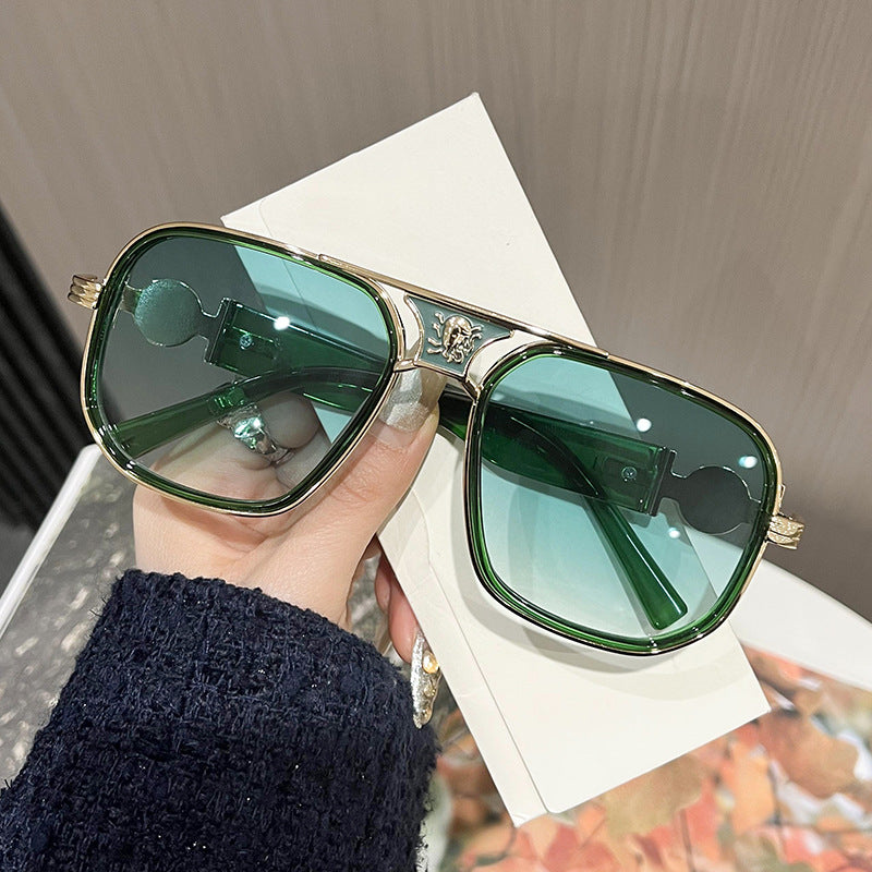 Oversized unisex sunglasses with green lenses, gold-tone rims and decorative hinge details
