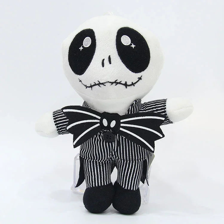 Plush stuffed doll with black oval eyes, striped overalls, and bow tie collar.
