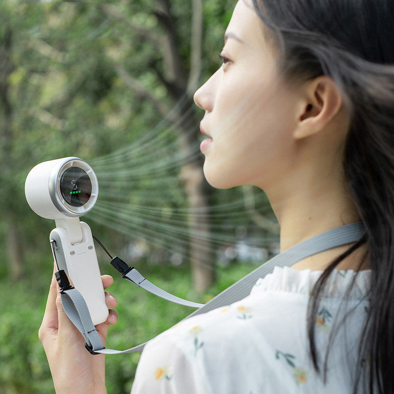 Person using a handheld device with a lens outdoors