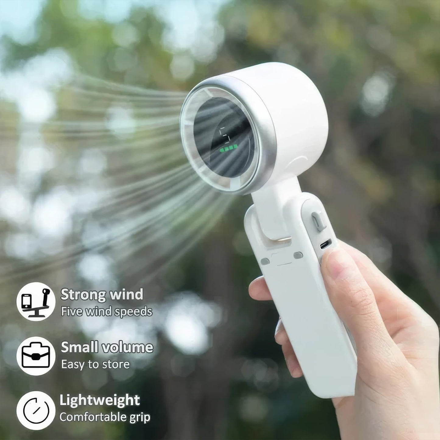 Handheld fan being used outdoors with features listed on the screen.
