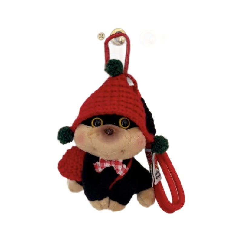 Plush keychain with a red hat and black outfit on a white background
