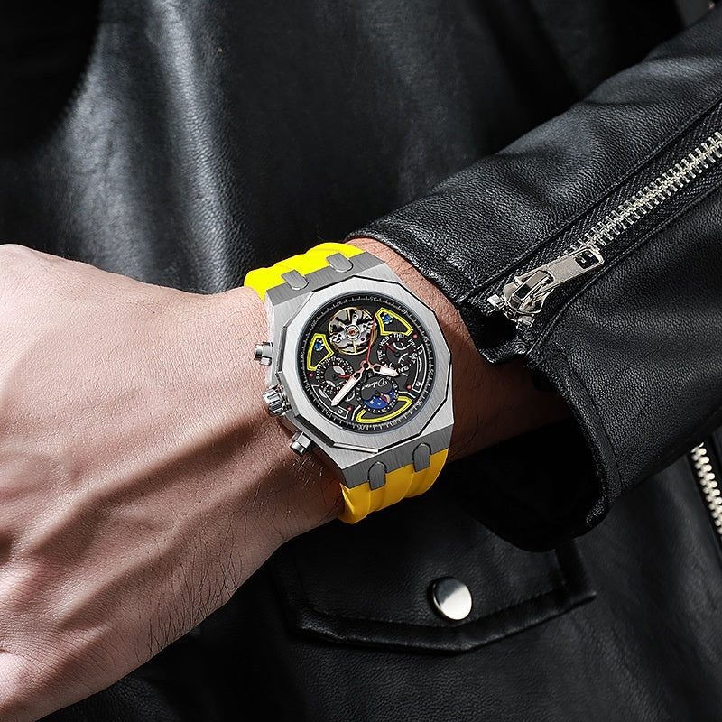 Close-up of a wrist wearing a watch with a yellow strap and black face, against a dark leather jacket background.