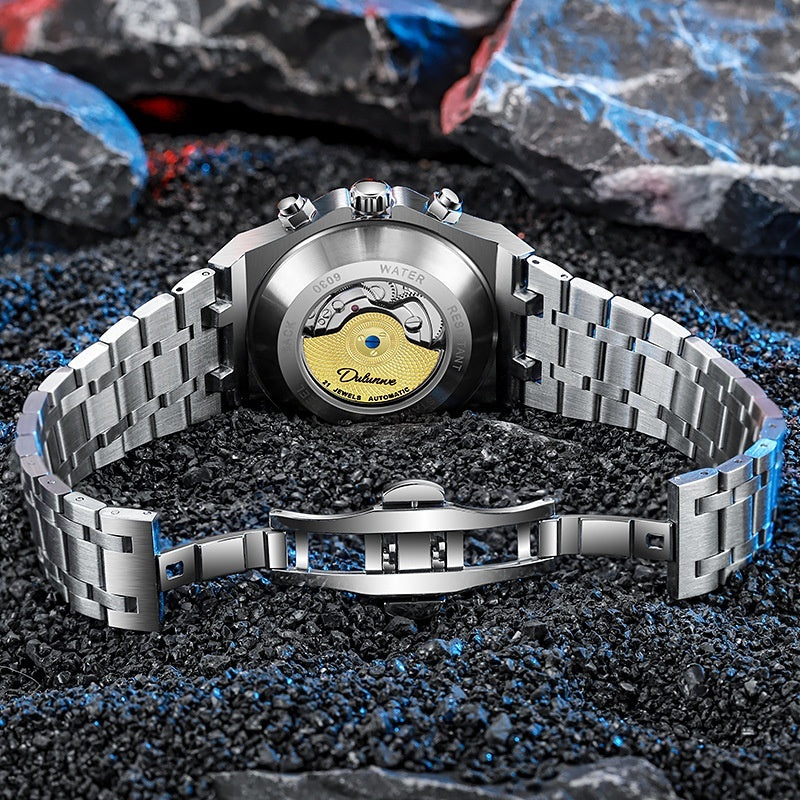 Silver watch with a detailed face on a textured surface