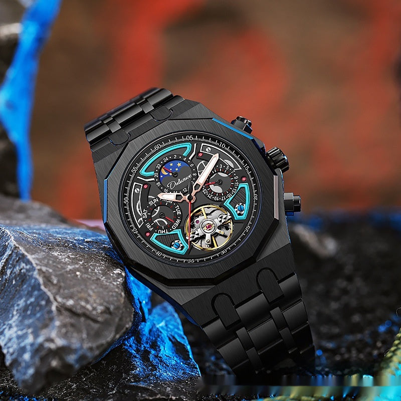 Black mechanical watch with blue accents on a rocky surface