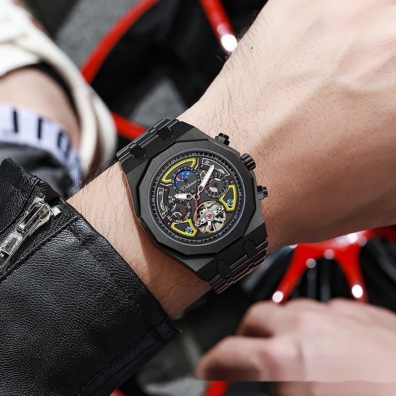Black wristwatch with detailed design on a person's wrist, wearing a black leather jacket.