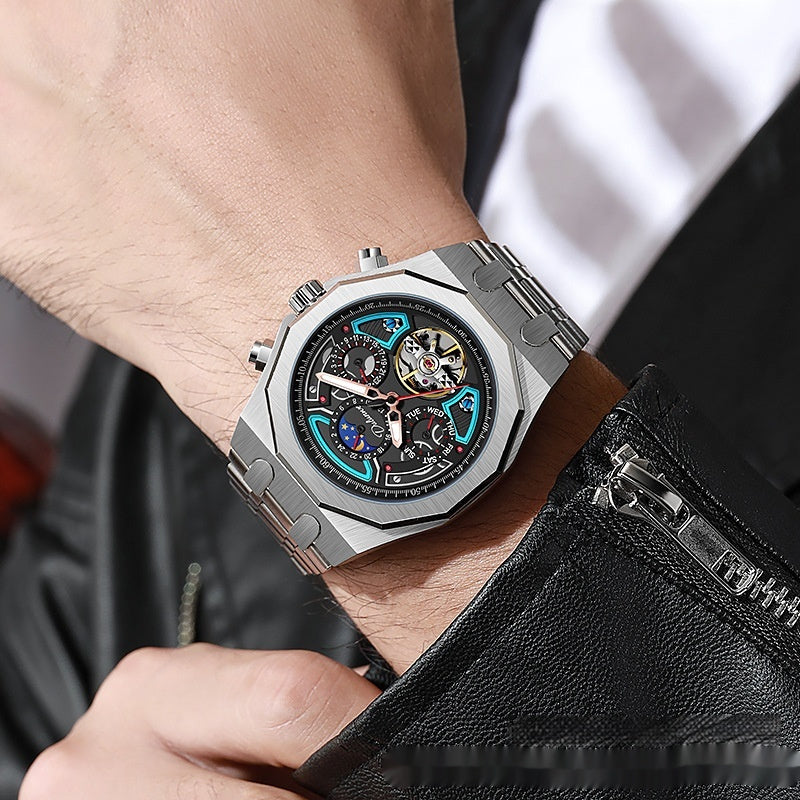 Close-up of a person wearing a silver wristwatch with a detailed face, holding a black leather jacket.