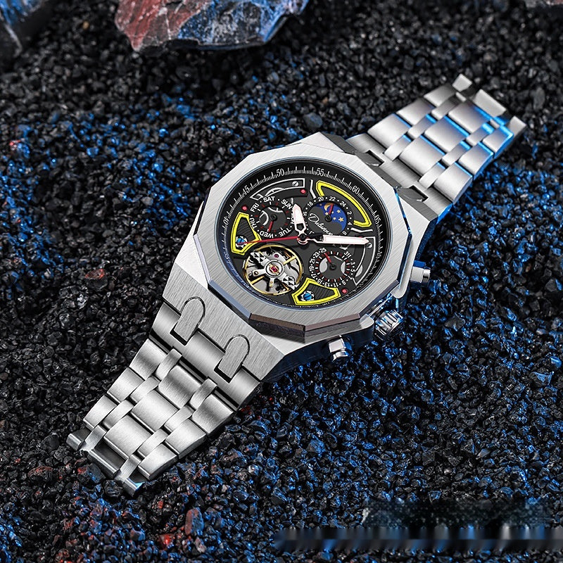 Silver wristwatch with a detailed face on a textured dark surface