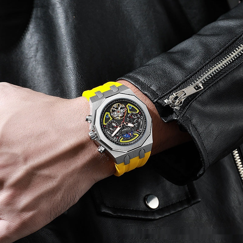 Watch with a yellow strap on a wrist, wearing a black leather jacket.