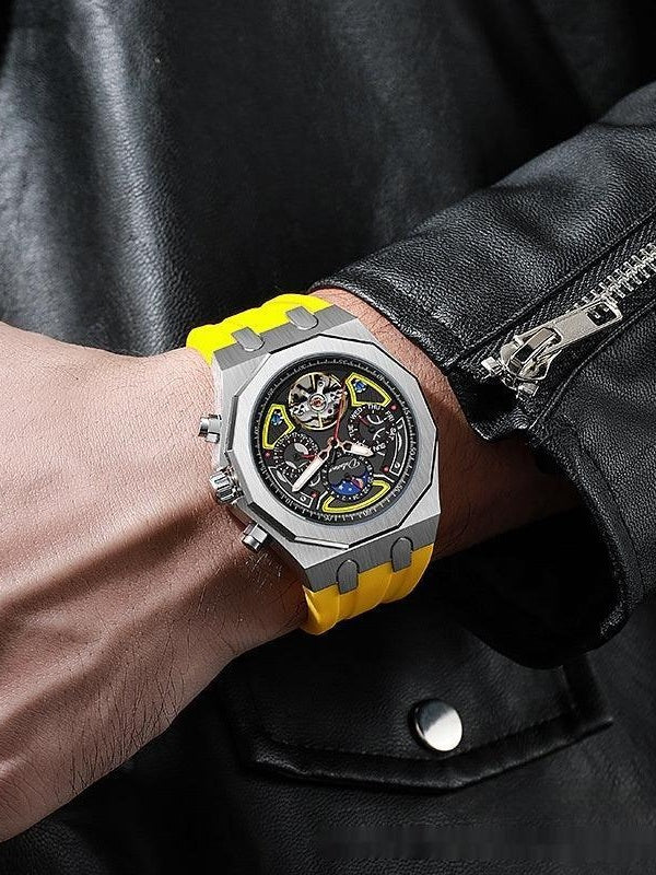 Automatic mechanical sports watch on wrist with black dial, silver-tone case, yellow strap