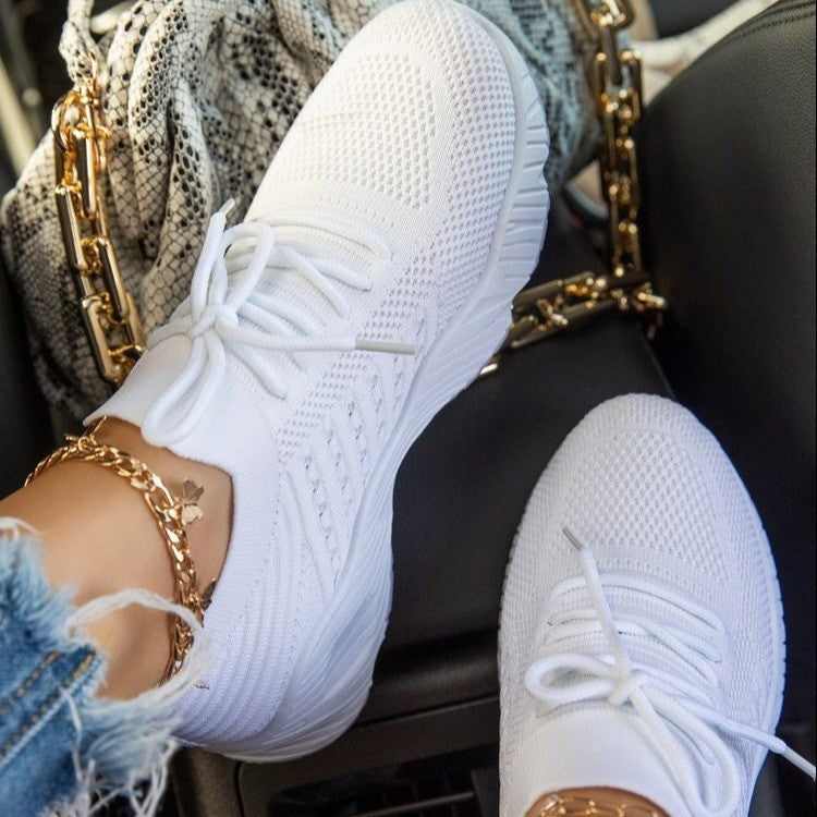 White women’s breathable knit sneakers with thick cushioned sole and lace-up design
