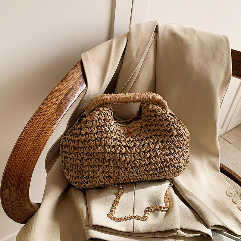 Woven handbag on a chair with a light-colored garment